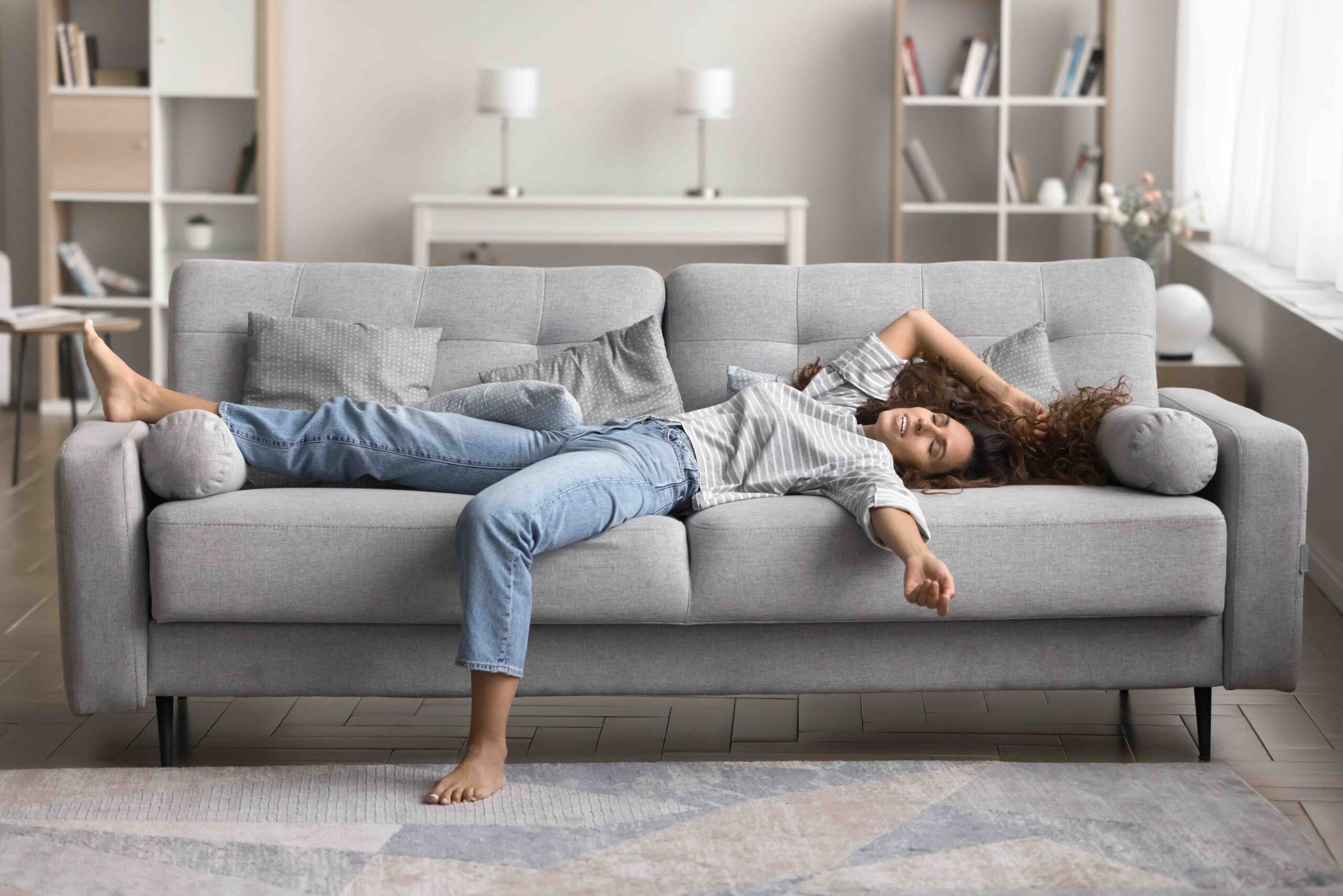 Pretty,Single,Woman,Lying,Sprawled,Out,On,Sofa,In,A